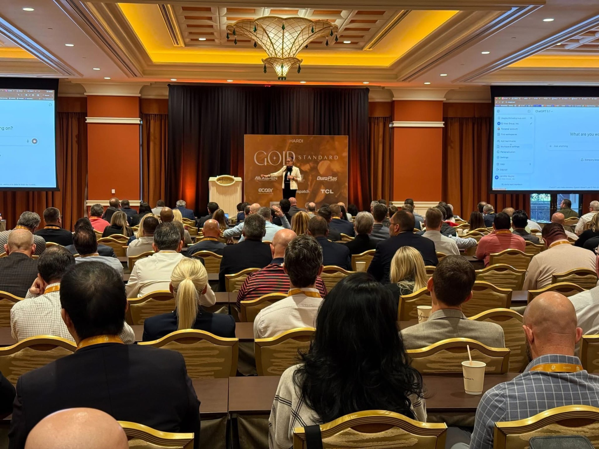 Jennifer Bagley presenting to a large audience at industry conference